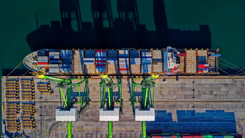 Aerial view of a container ship being loaded at a port